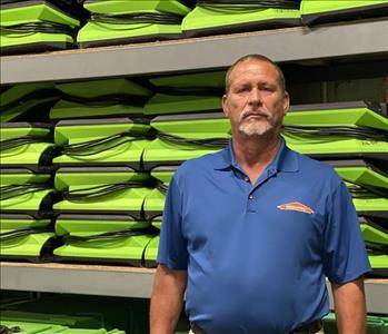 Man in front of green SERVPRO equipment